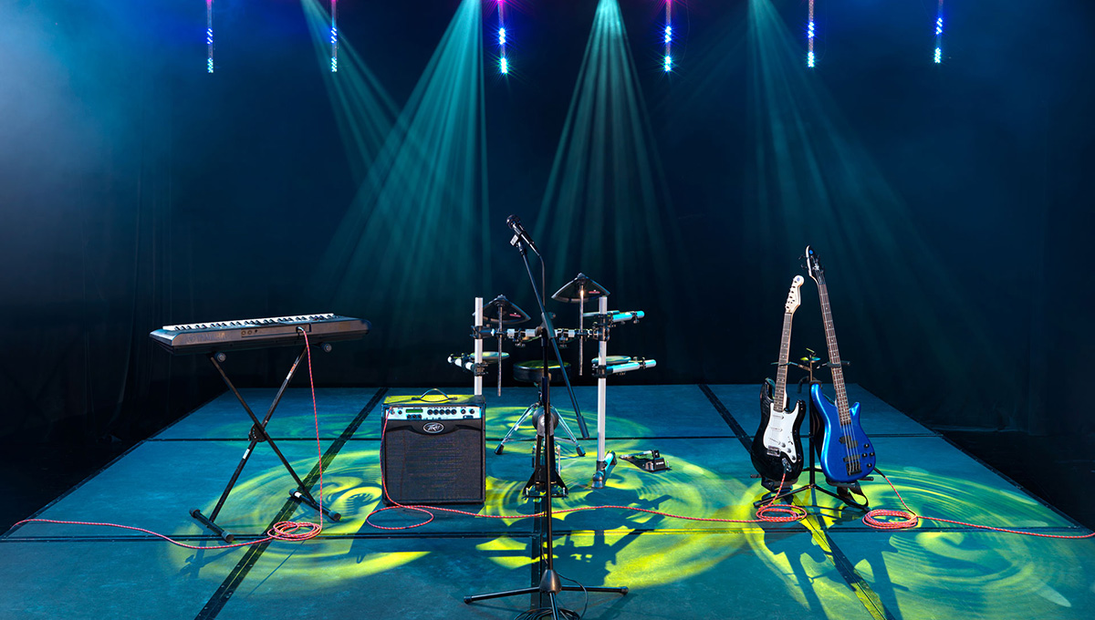 a stage with musical instruments and lights