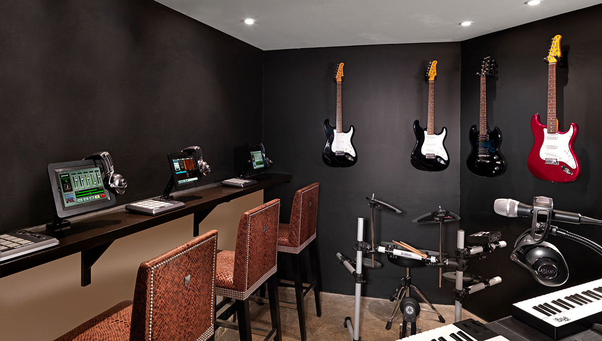 a room with a piano keyboard and electric guitars