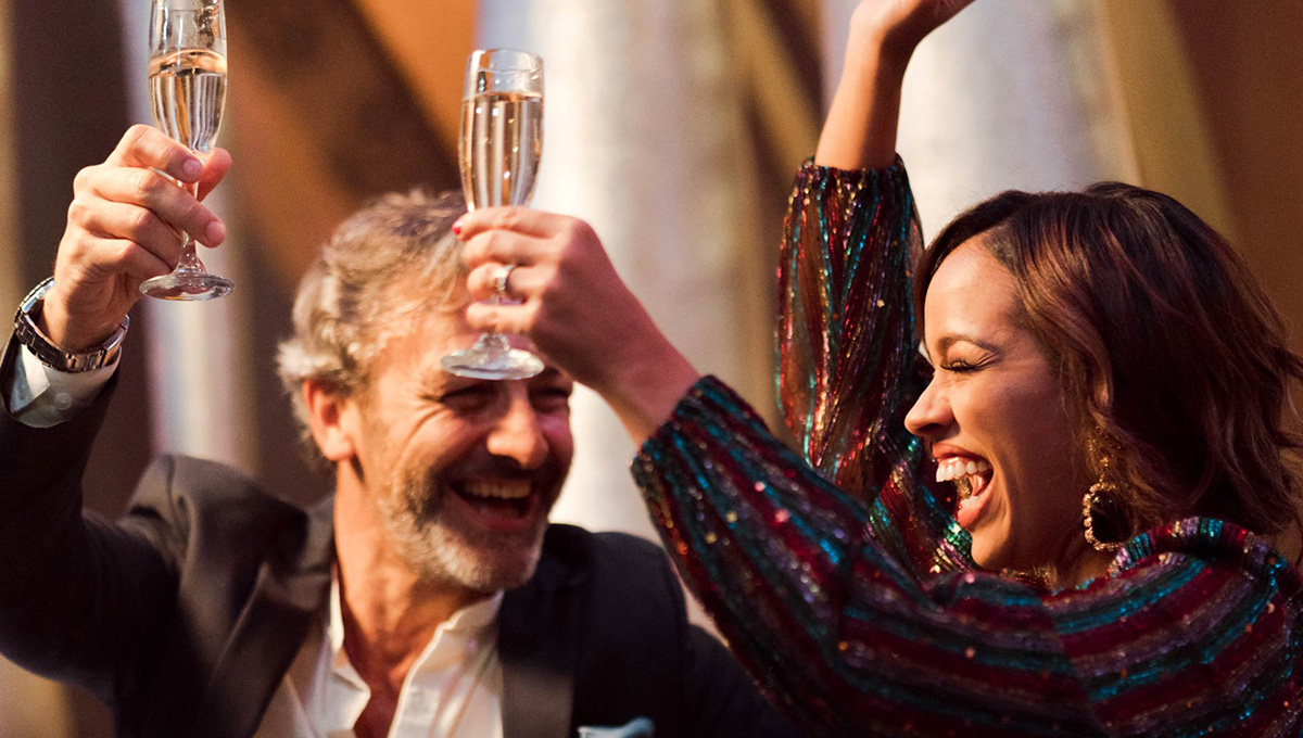 a man and woman holding wine glasses