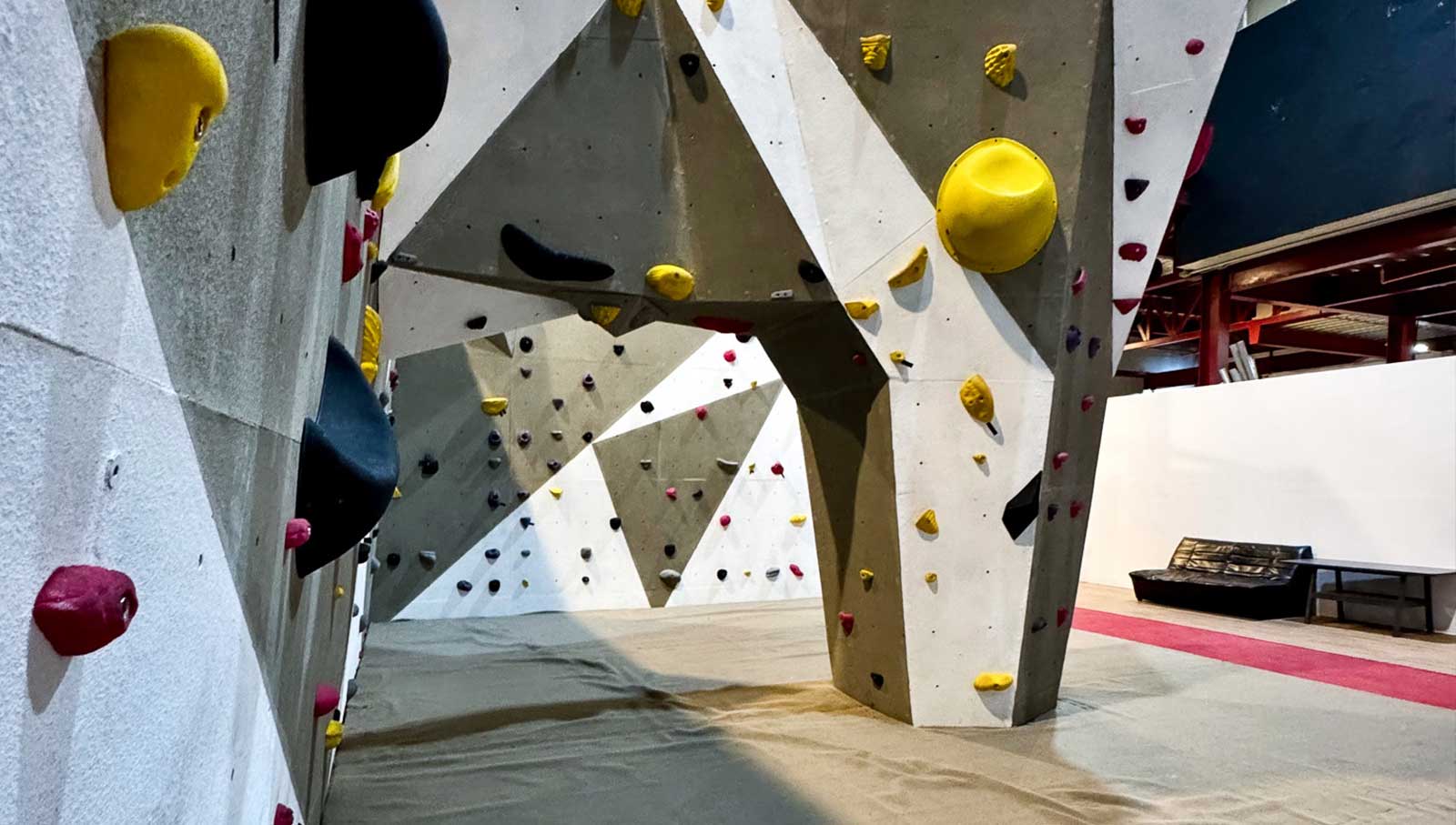 a rock climbing wall with many colorful climbing walls