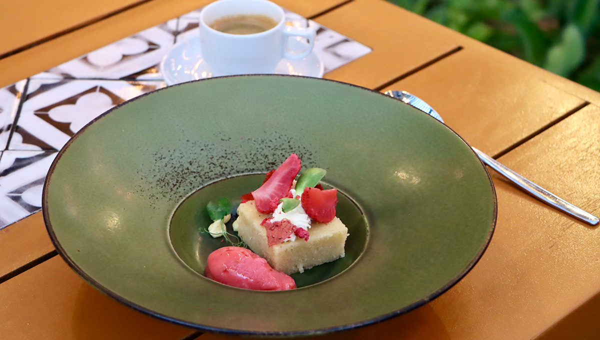 a plate of dessert with strawberries and ice cream